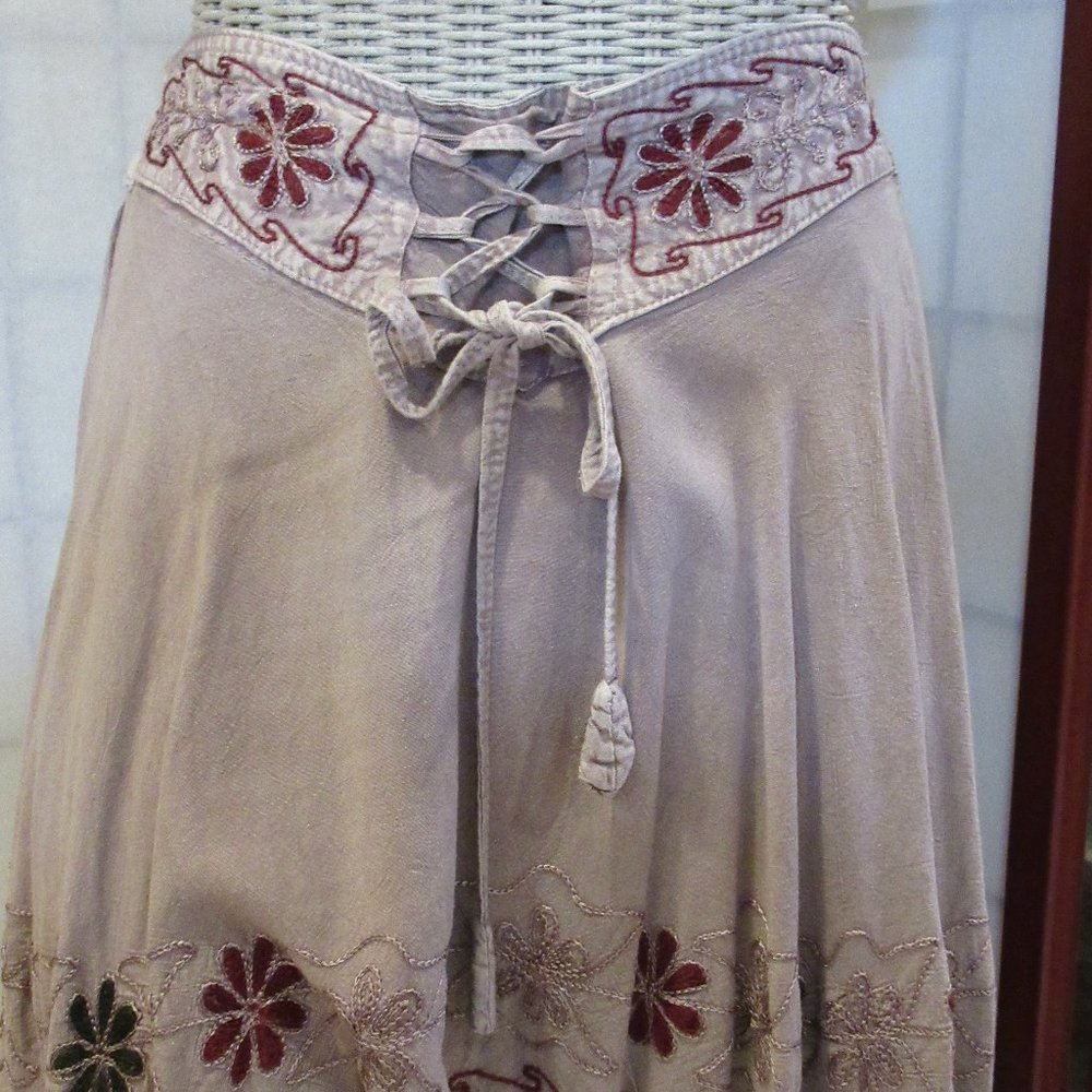 Fringe skirt with embroidered flowers. Elastic in back on waist, tie front.